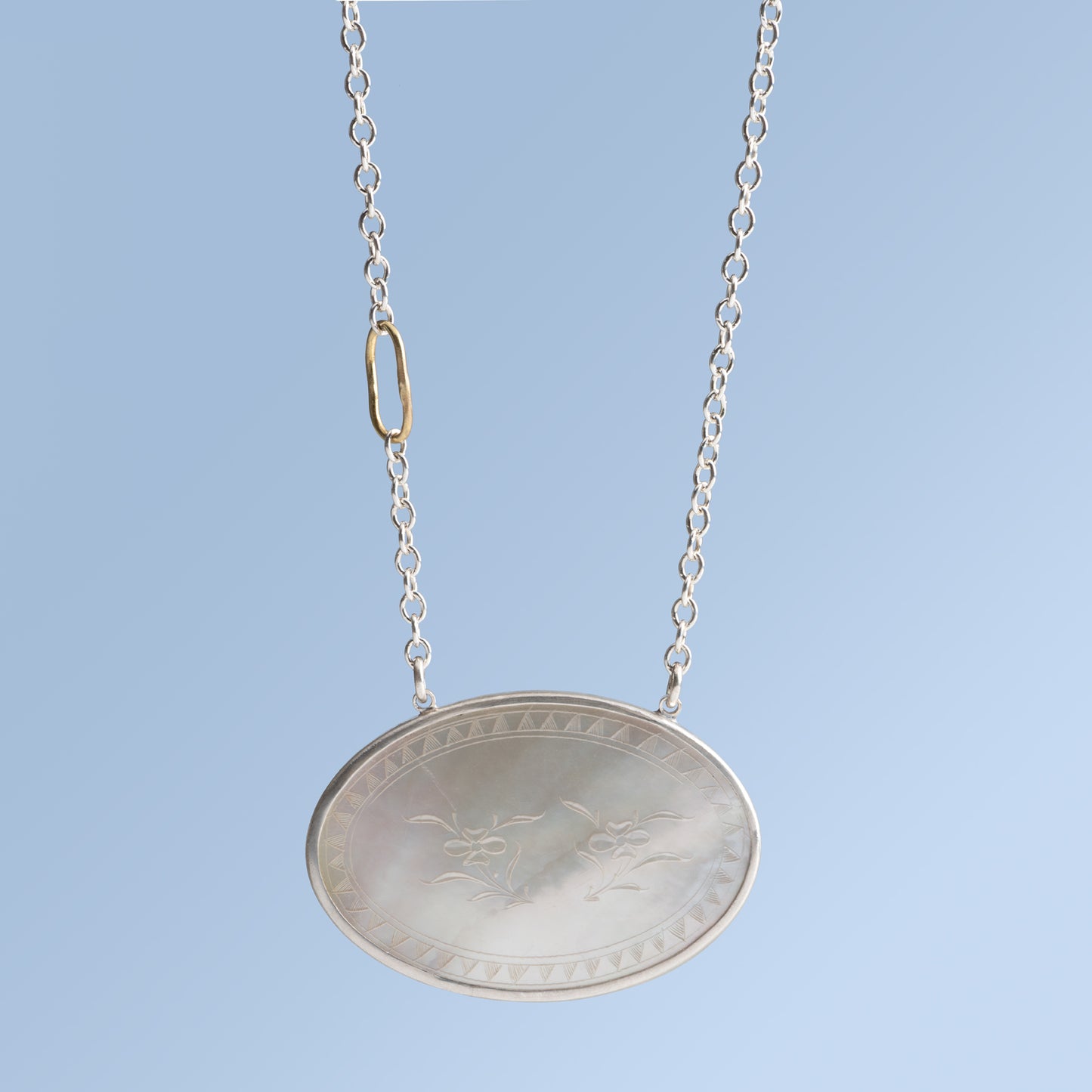 Antique Mother of Pearl Pendant Set in Sterling Silver on a Silver Chain with an 18 Karat Gold Oval